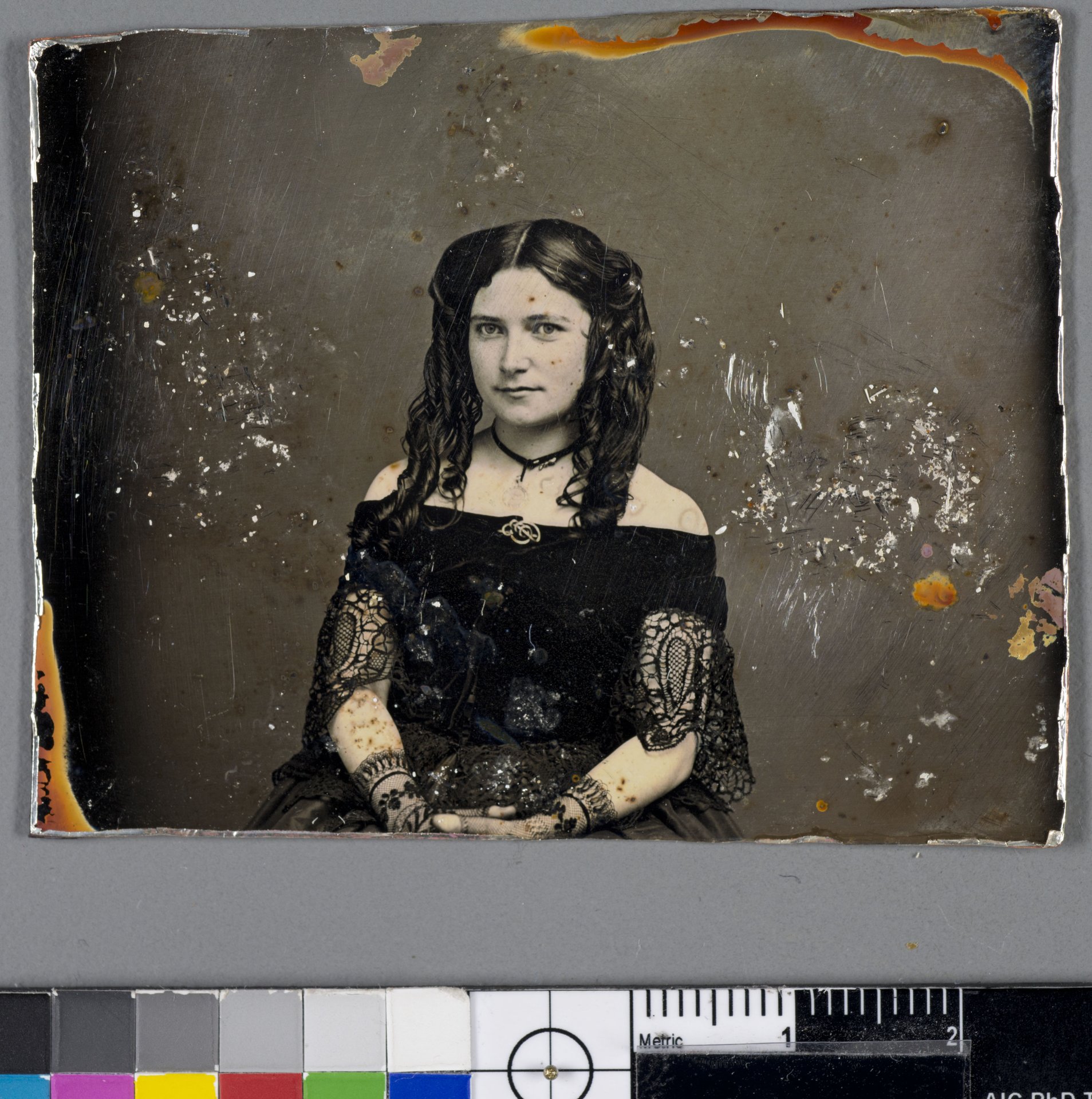Conserved daguerreotype from the SS Central America with conservation scale and colour chart